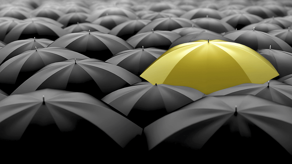 Umbrellas black and one yellow